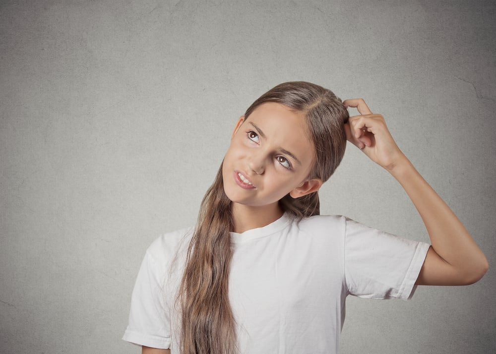Confused, remembering. Portrait teenager girl scratching head, thinking daydreaming about something, looking up isolated grey wall background. Human facial expression, emotion, feeling body language