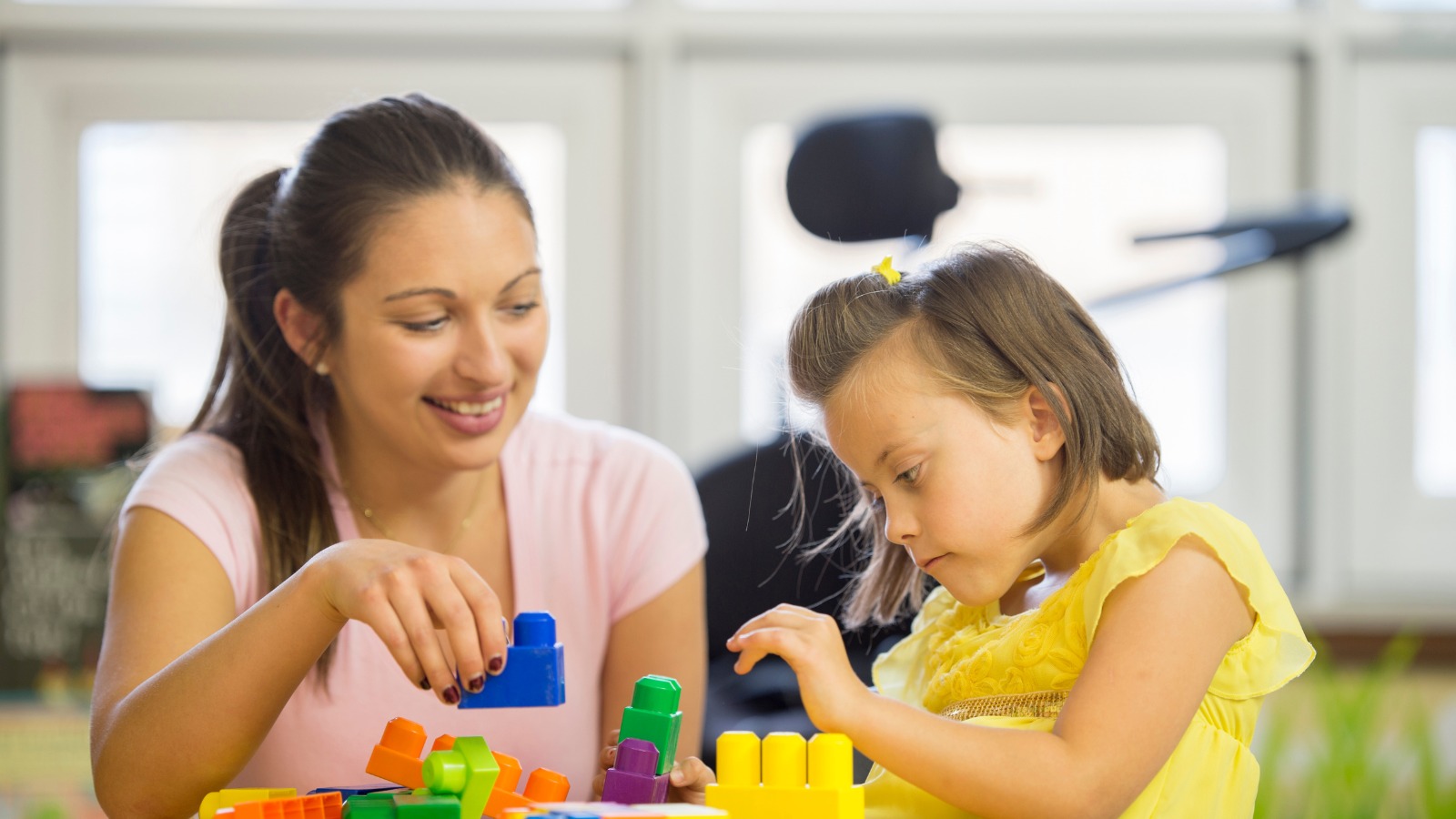 SEND-Woman-playing-building-blocks-with-young-child SEND-Woman-playing-building-blocks-with-young-child